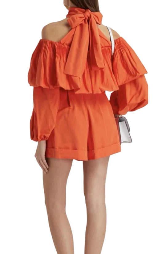 Orange off-shoulder dress with ruffled layers on a white background