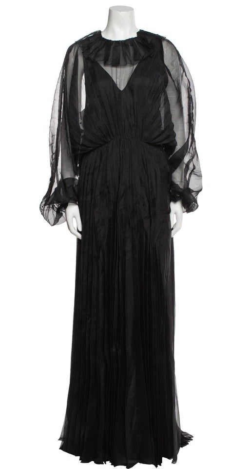 Black evening gown with sheer sleeves on a mannequin against a white background