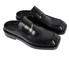 Black sandals with a buckle on a white background