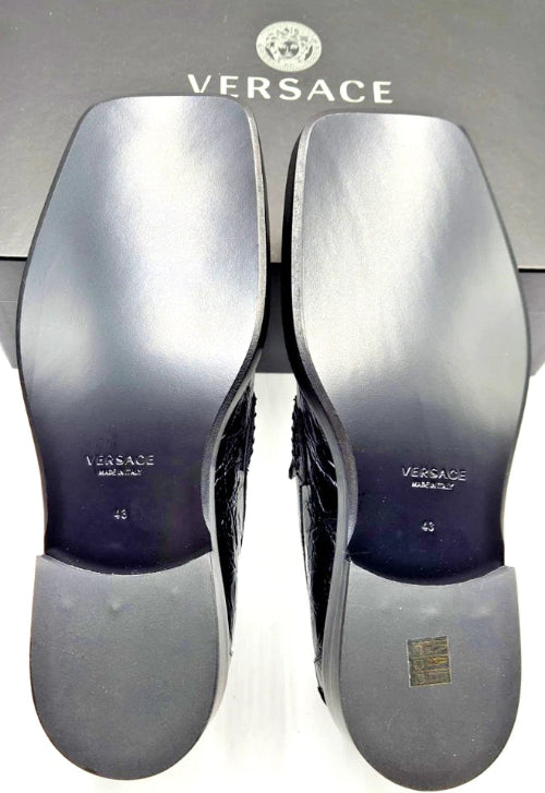 Versace shoes with silver soles on a Versace branded box.