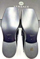 Versace shoes with silver soles on a Versace branded box.