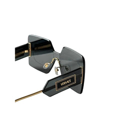 Versace sunglasses with a dark gray acetate frame and gold-tone metal temples, shown with their signature black Versace packaging box.