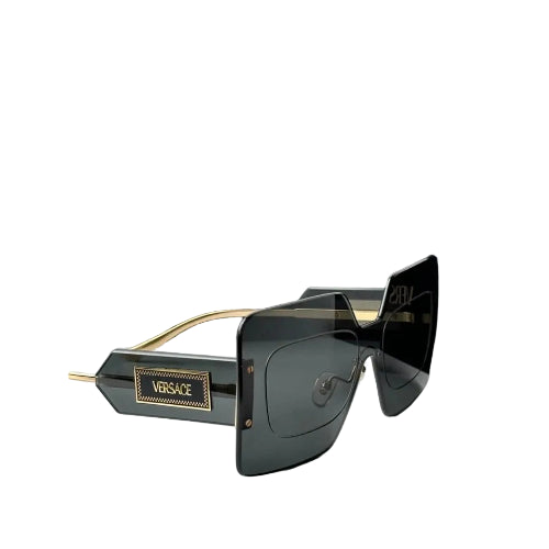 Versace oversized square sunglasses with dark gray lenses, gold metal accents, and a black branded box in the background.