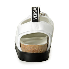 White sandal with cork sole and Versace logo on a white background