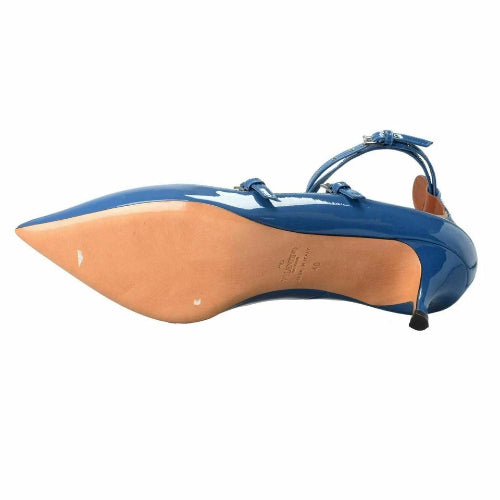 Blue high-heeled shoe with tan insole on a white background