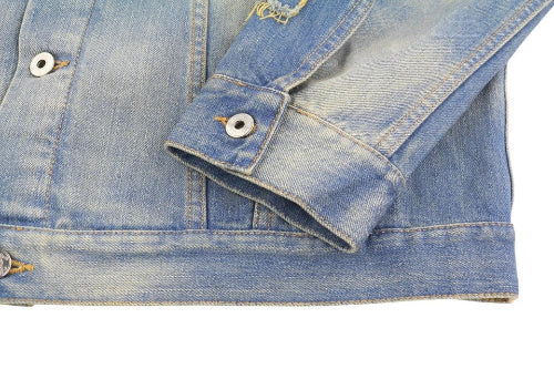 Close-up of a blue denim jacket with buttons on a white background