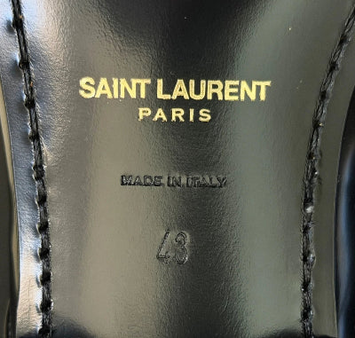 Saint Laurent label on a black leather shoe with 'Made in Italy' text.