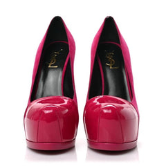 A pair of Yves Saint Laurent high-heeled pumps in glossy patent pink and magenta suede, featuring a black insole with a gold YSL logo, shown against a plain white background.